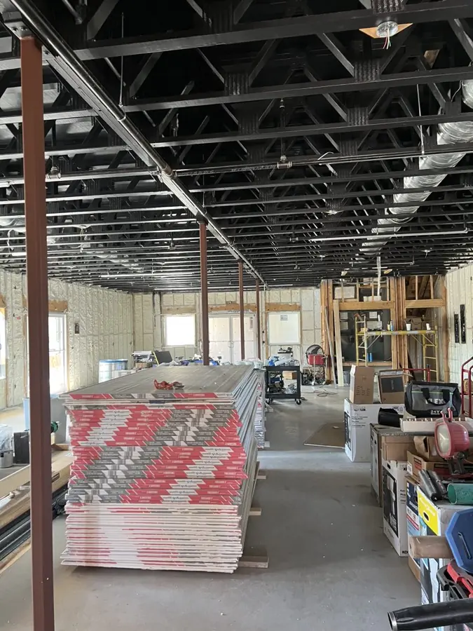 Commercial building under construction with steel framing and insulated walls